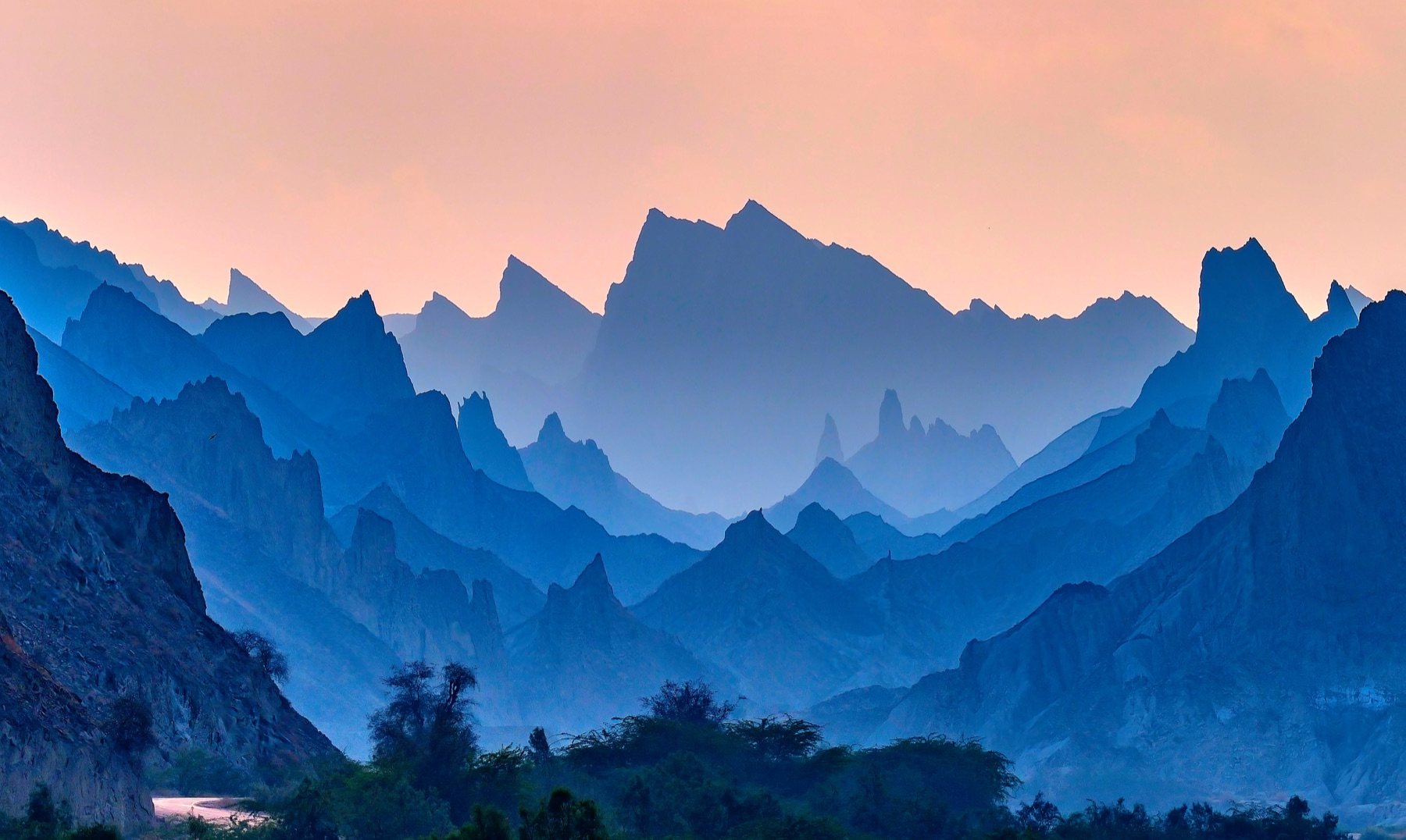 Blue hour over the Hingol badlands, ridges turning indigo beneath a rose sky