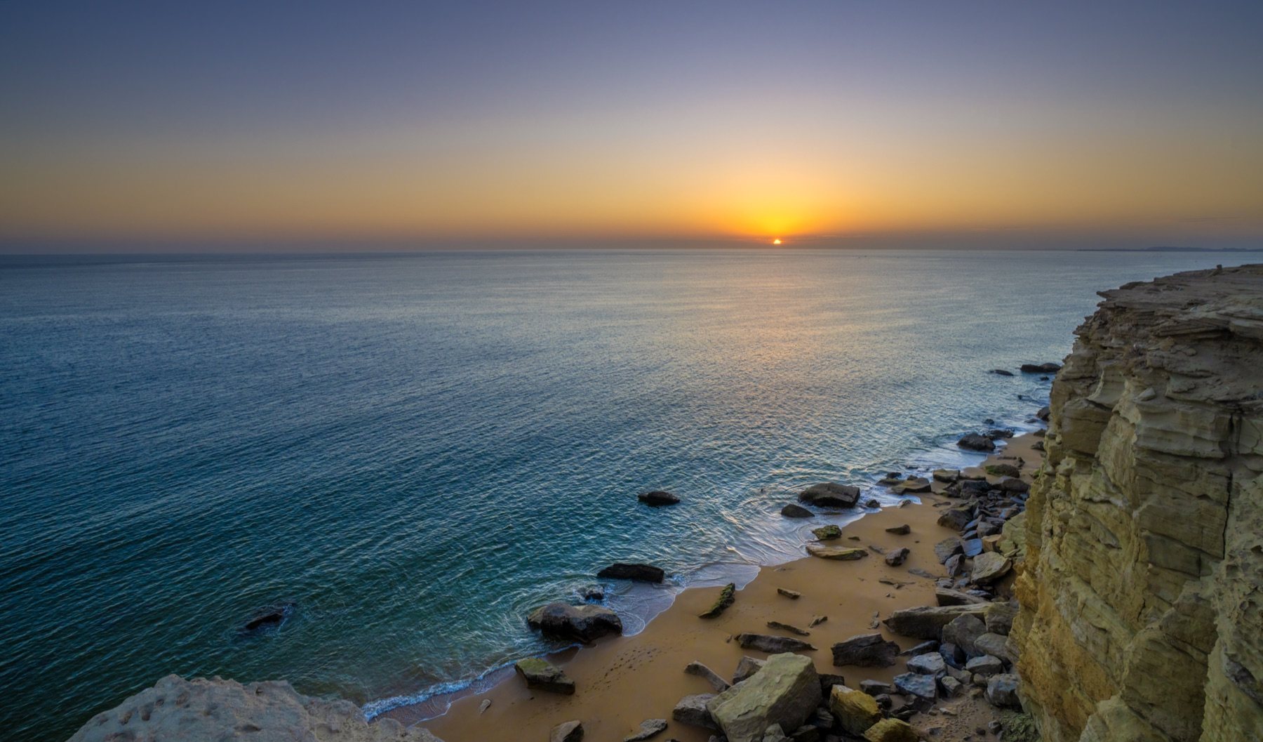Sunset from the cliffs above Golden Beach, Gwadar, over a calm Arabian Sea
